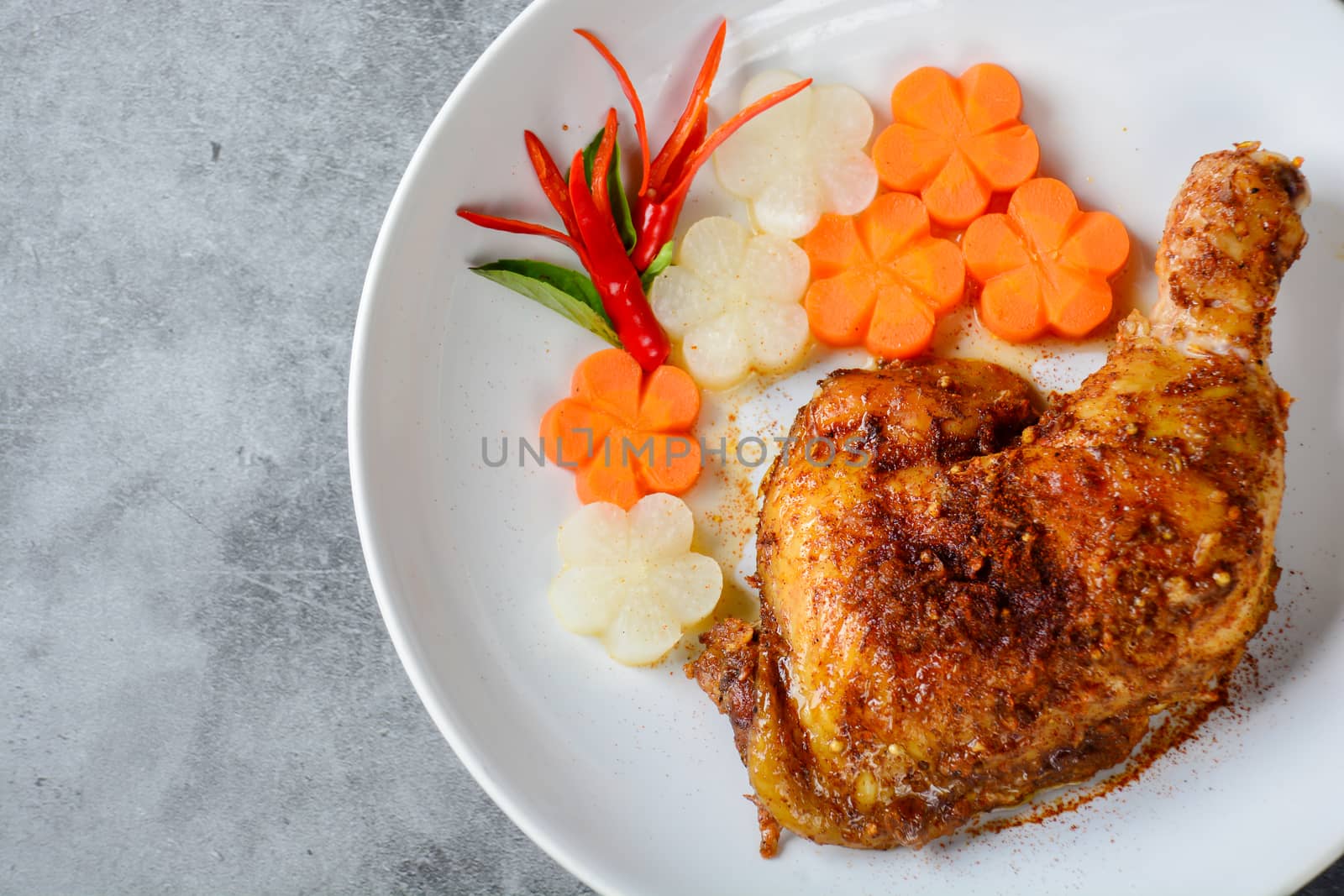 Hot and spicy baked chicken on white plate by yuiyuize