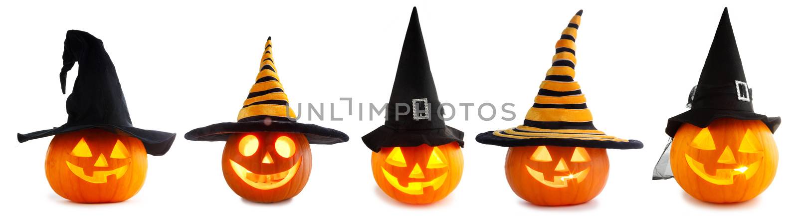 A collection of Jack O Lantern Halloween pumpkins with various different designs and witches hat in a row isolated on white background