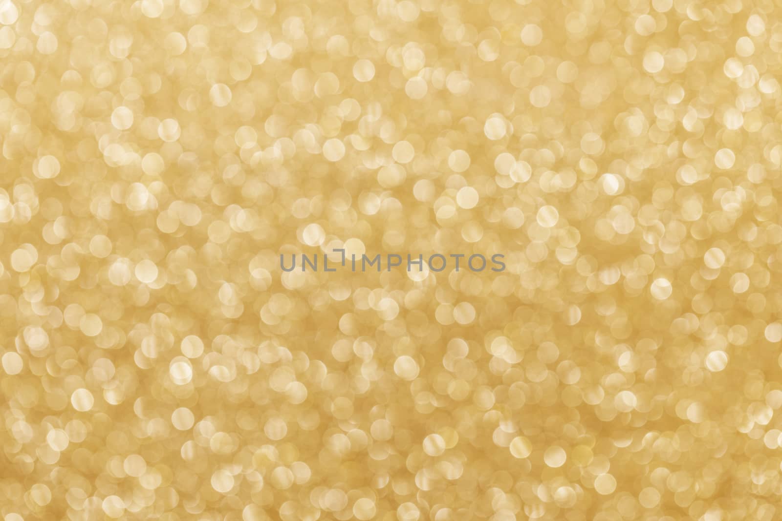 Golden festive glitter background with defocused lights