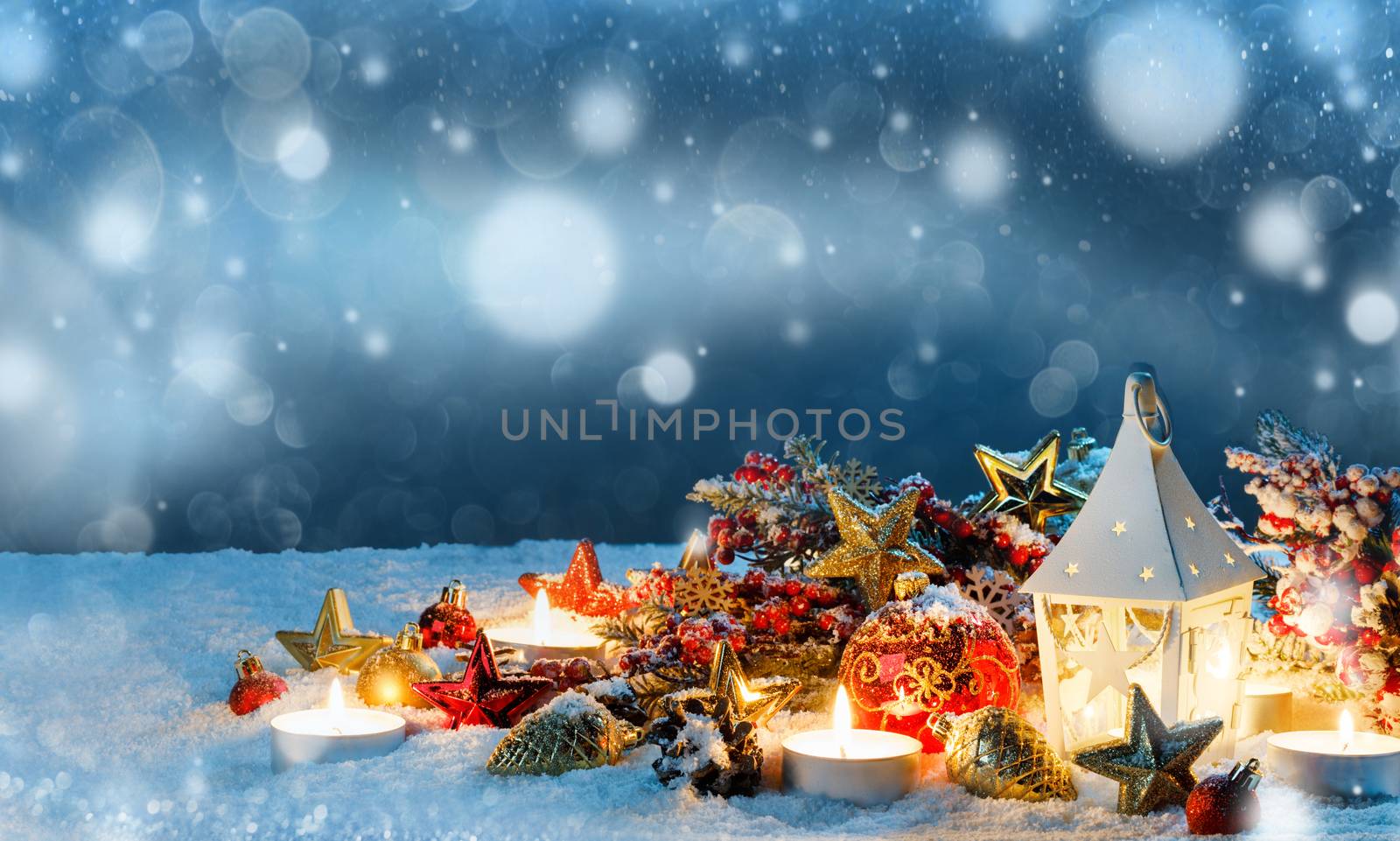 Burning candles , lantern and christmas decoration on magic bokeh lights background