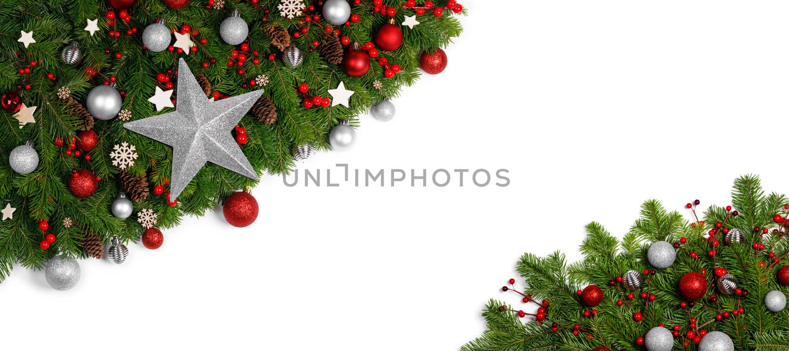 Christmas Border frame of tree branches around white background with copy space isolated, red decor, berries, stars, cones, candy canes