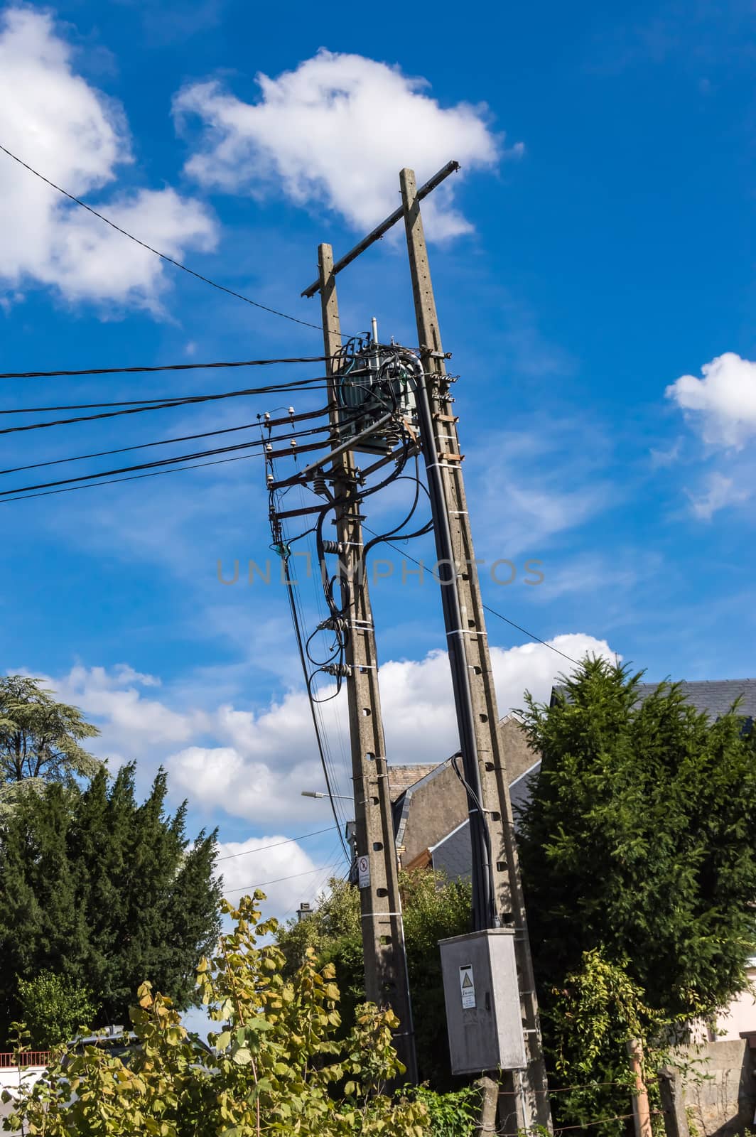 Power line concrete pole end with cables falling vertically. Power Line Concrete Pole End with Vertically Falling Cables and a Height Transformer