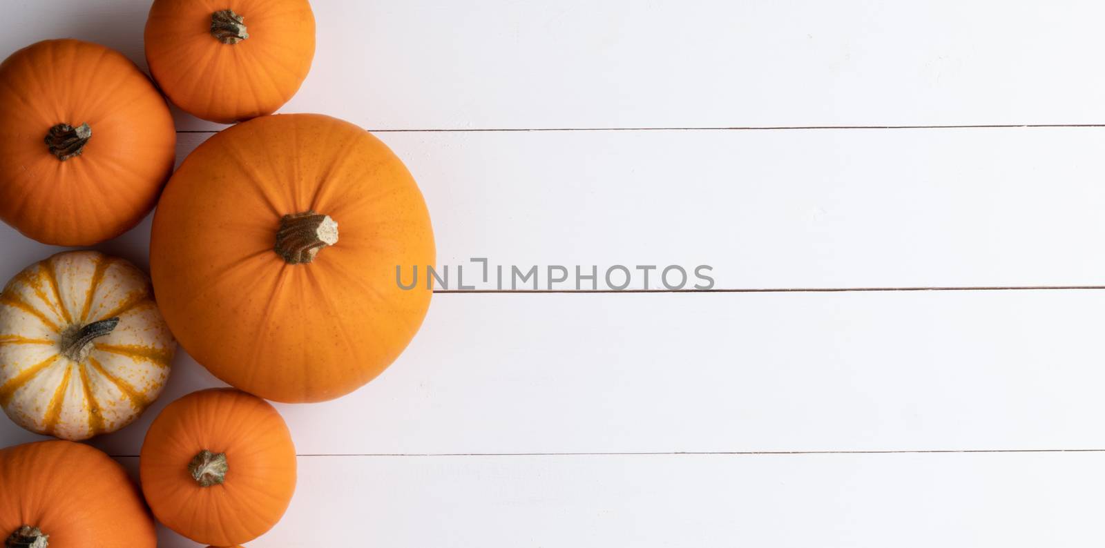 Pumpkins on wooden background by Yellowj