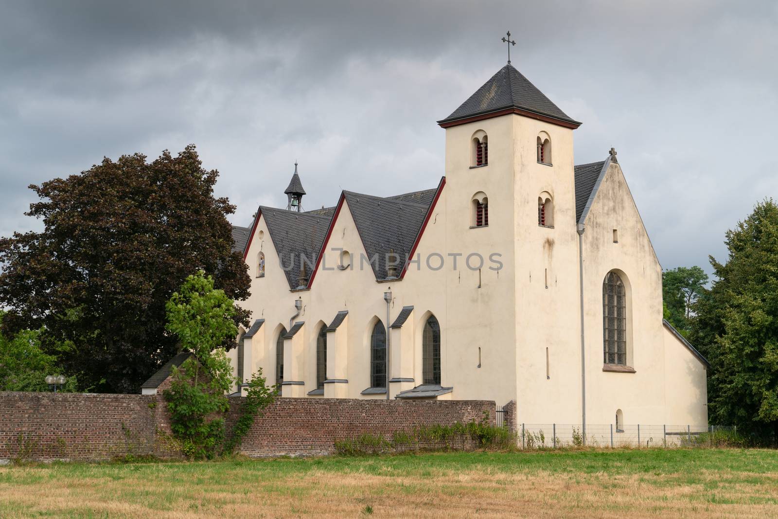 Panoramic image of the old parish church of Cologne Duennwald on a cloudy day, Germany