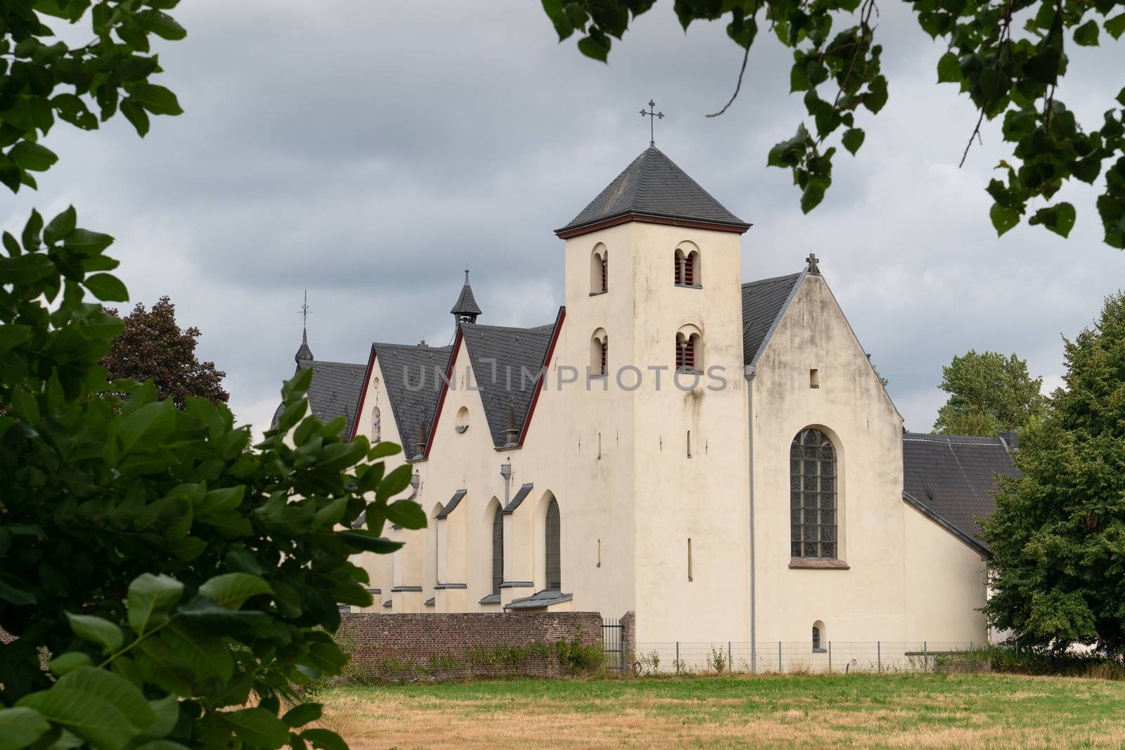 Panoramic image of the old parish church of Cologne Duennwald on a cloudy day, Germany