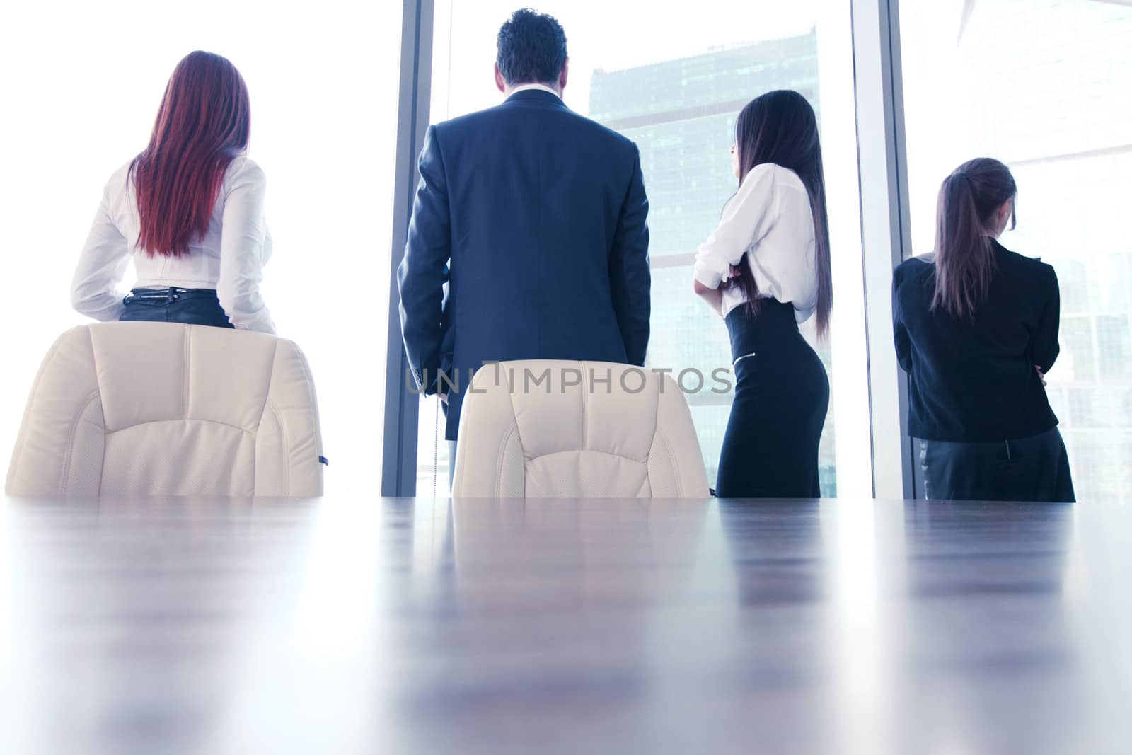 Rear view of business people looking at window