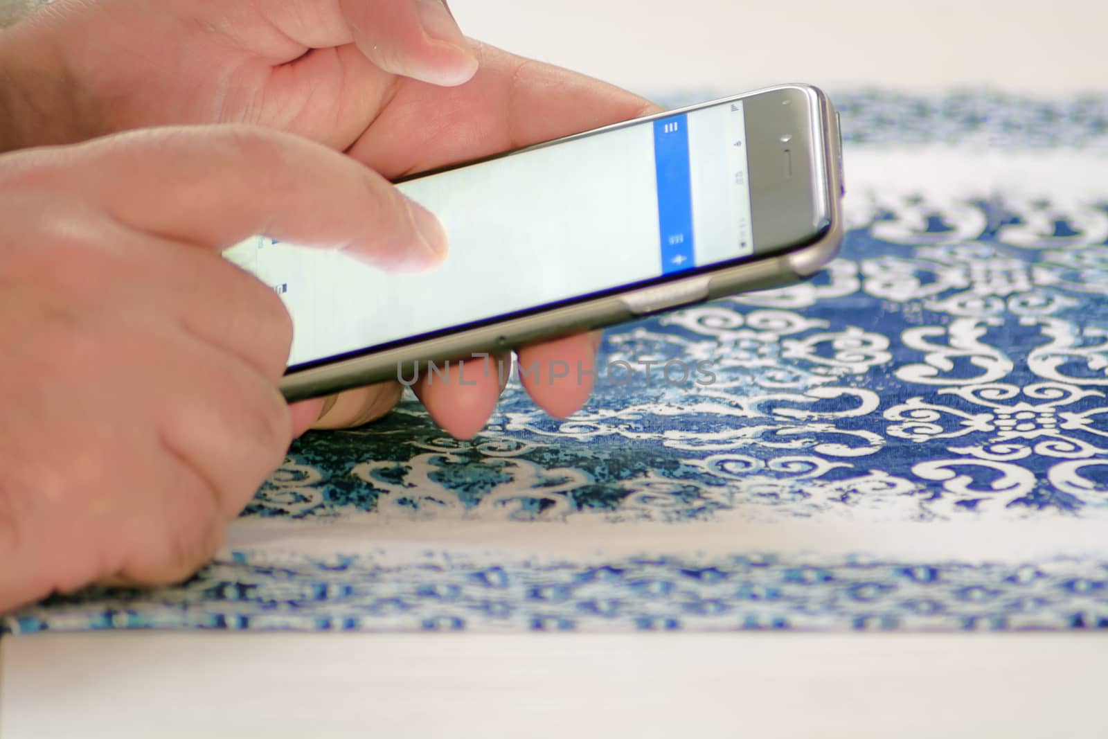 Male hand checking mail using a smartphone by touching the screen with fingers