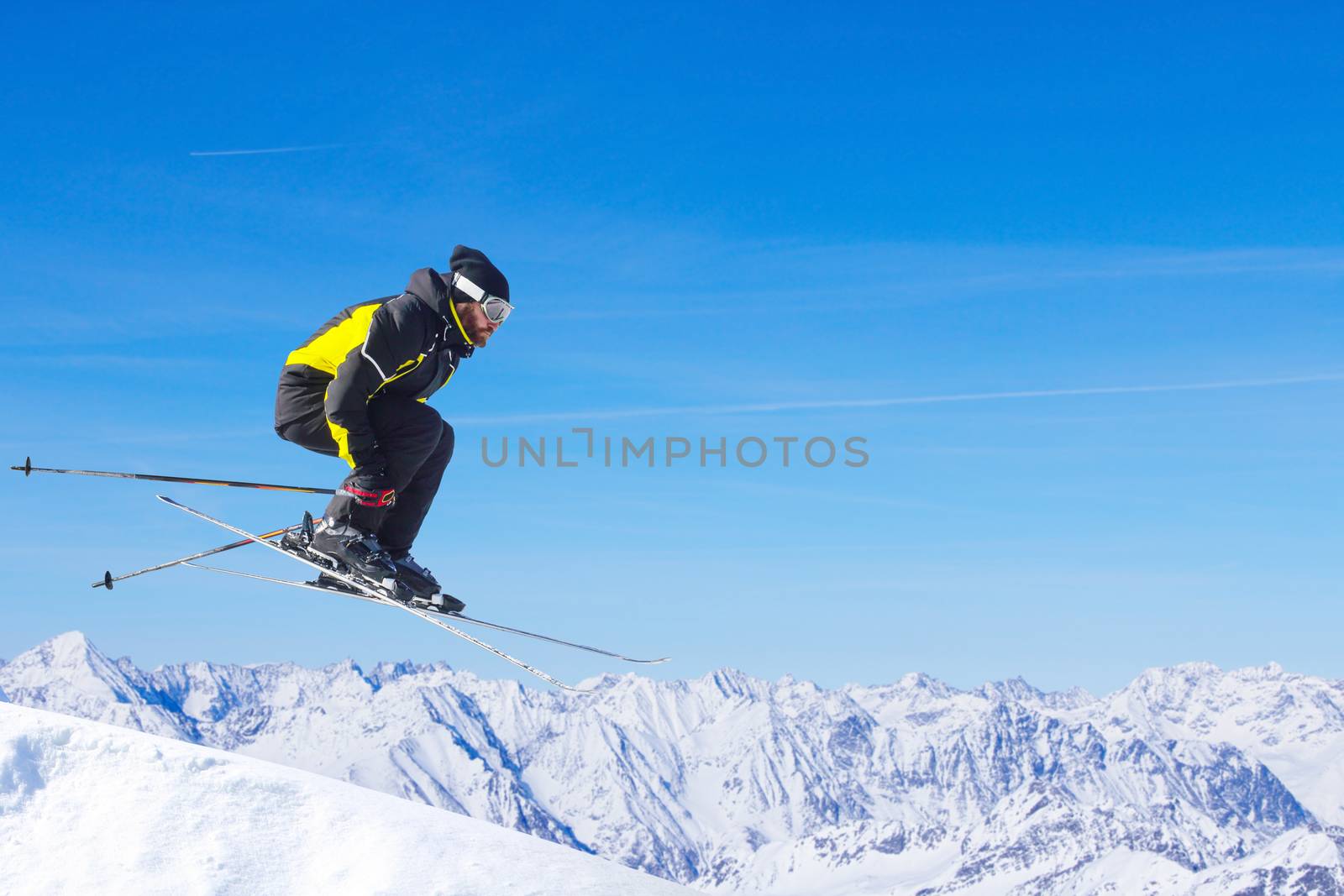 Jumping skier at mountains by destillat