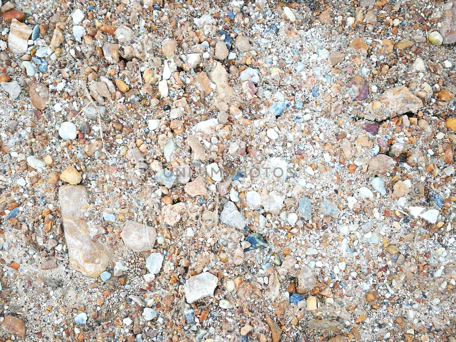 Blur small stones and sands on the road used as background or texture. Close up textured stone.
