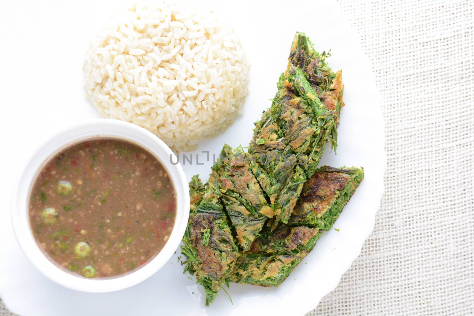 Shrimp Paste Sauce and Fried Egg with Climbing Wattle (Acacia Pennata), served with cooked rice.
