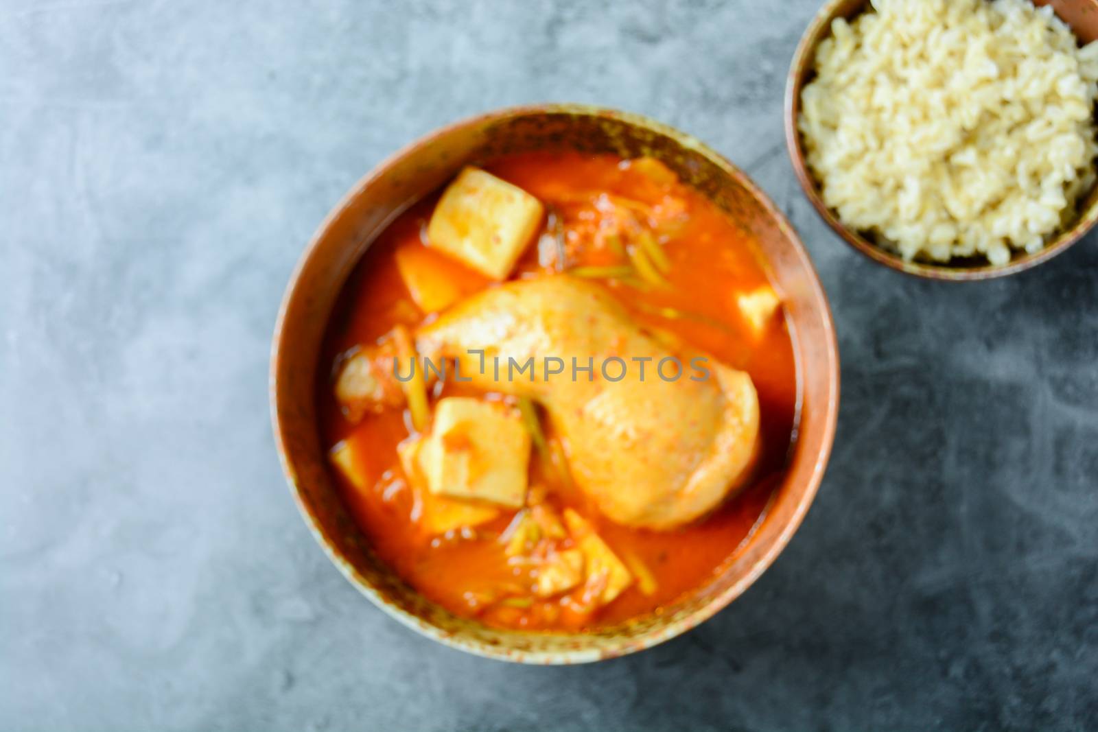 Korean traditional Kimchi soup with chicken and soft tofu
