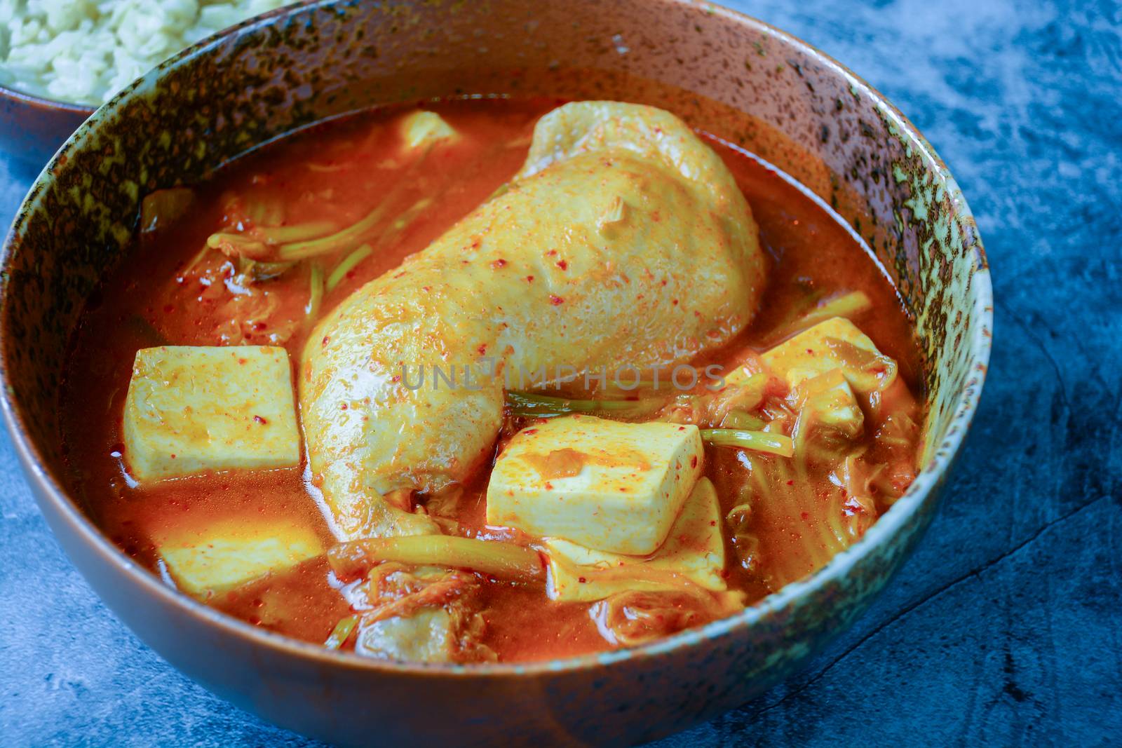 Korean traditional Kimchi soup with chicken and soft tofu
