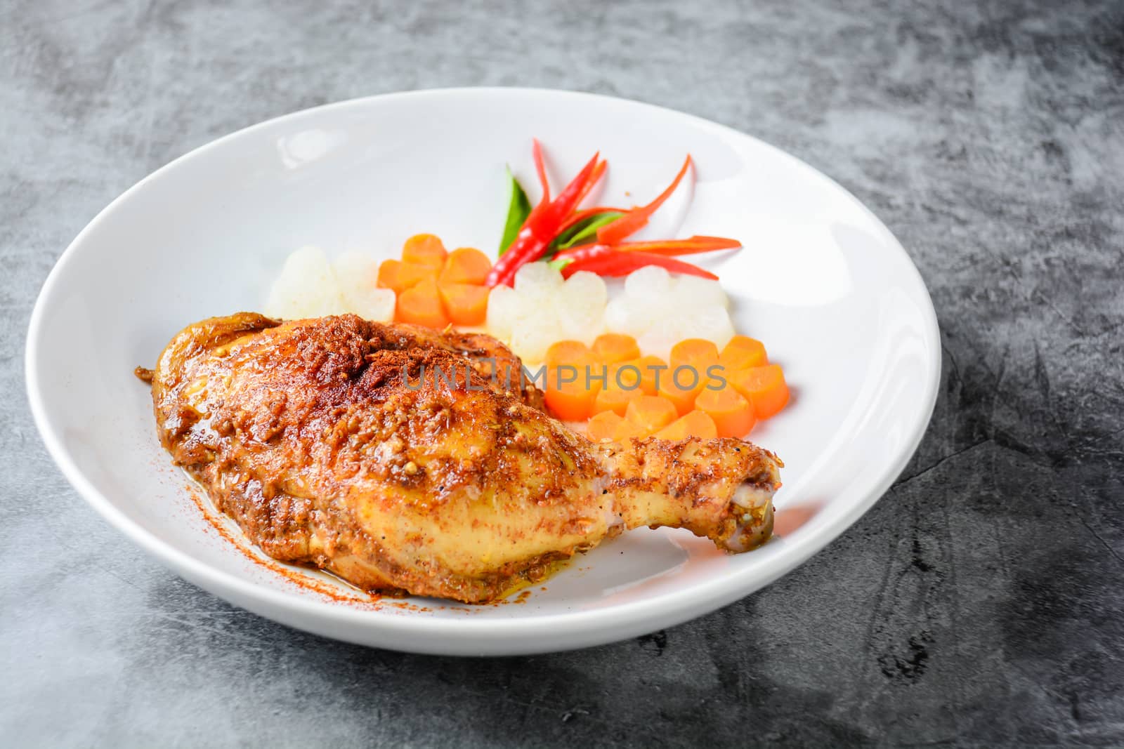 Hot and spicy baked chicken on white plate by yuiyuize