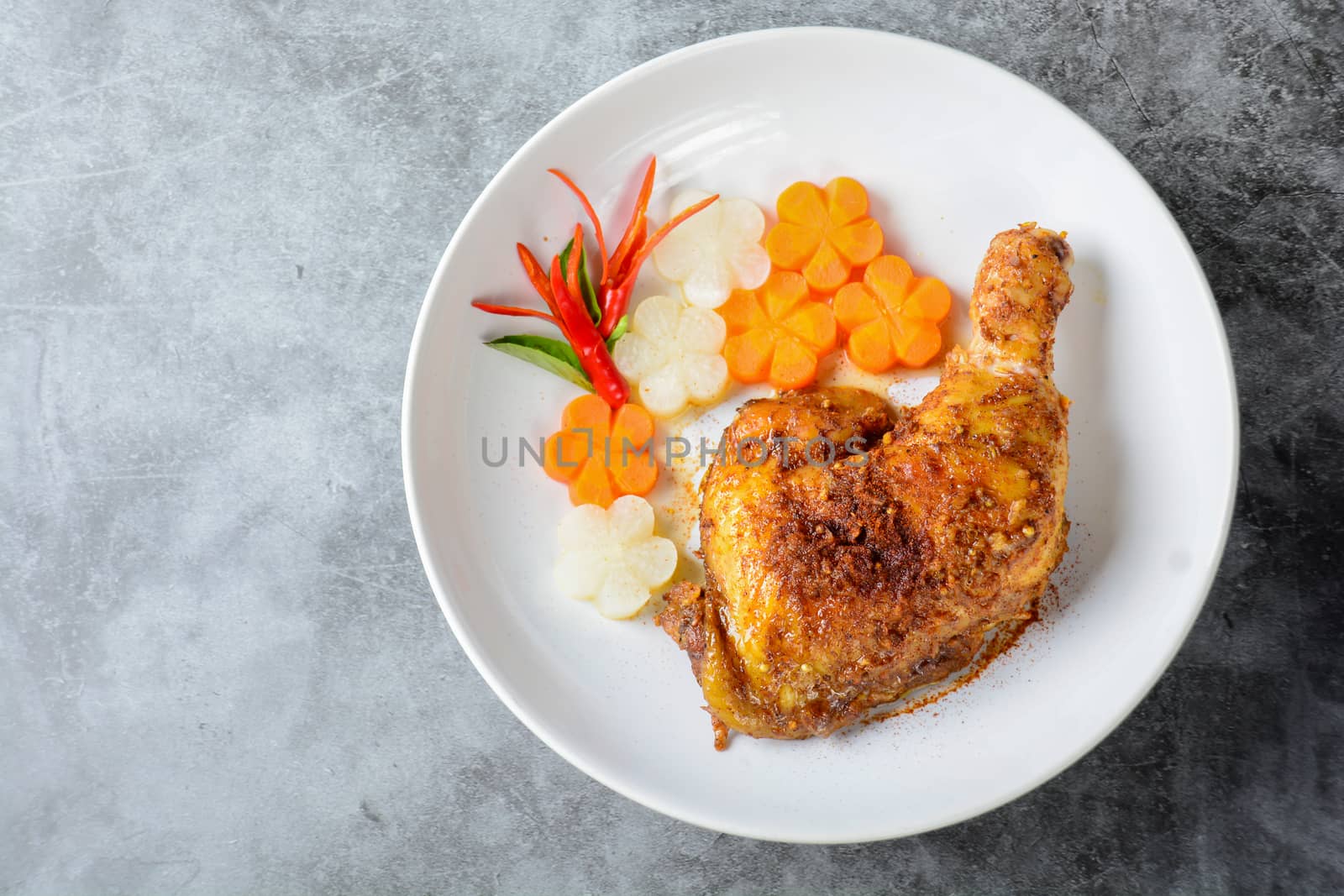 Hot and spicy baked chicken on white plate
