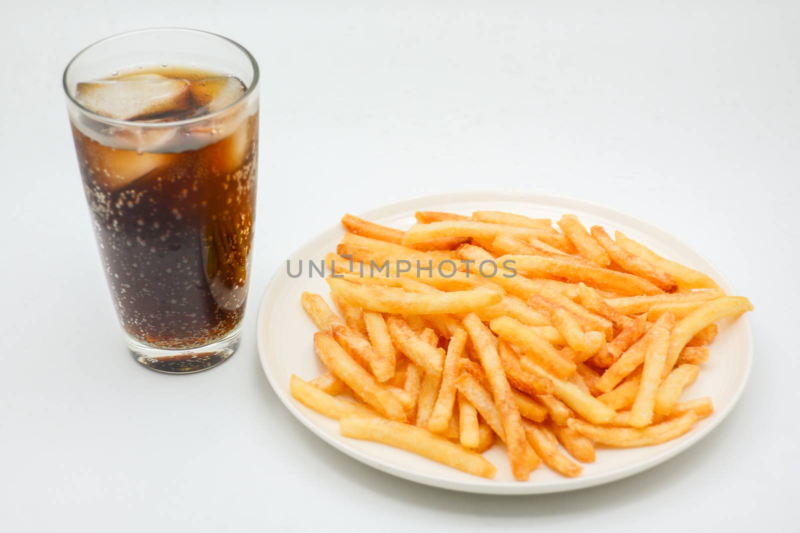 French fries on white dish and white background.