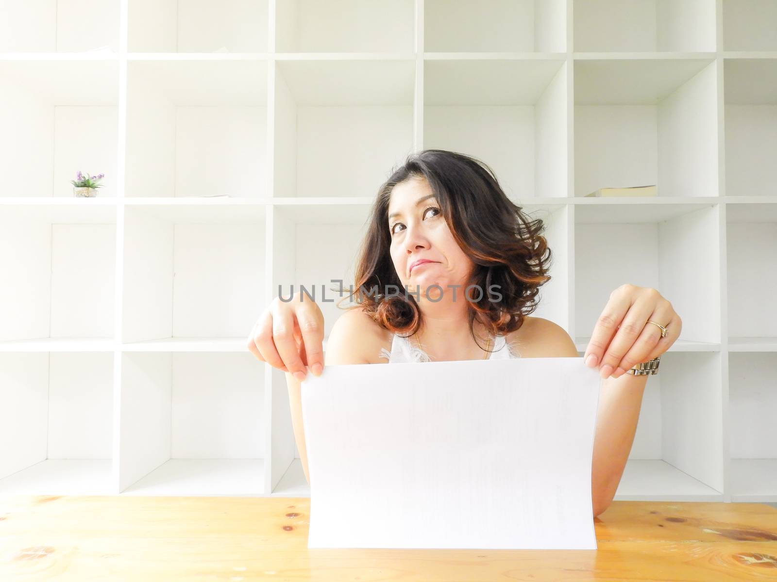 Attractive beautiful woman holding blank white paper.
