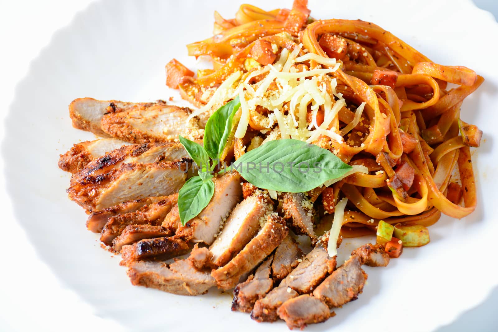 Steak meat with spaghetti and cheese on white background.