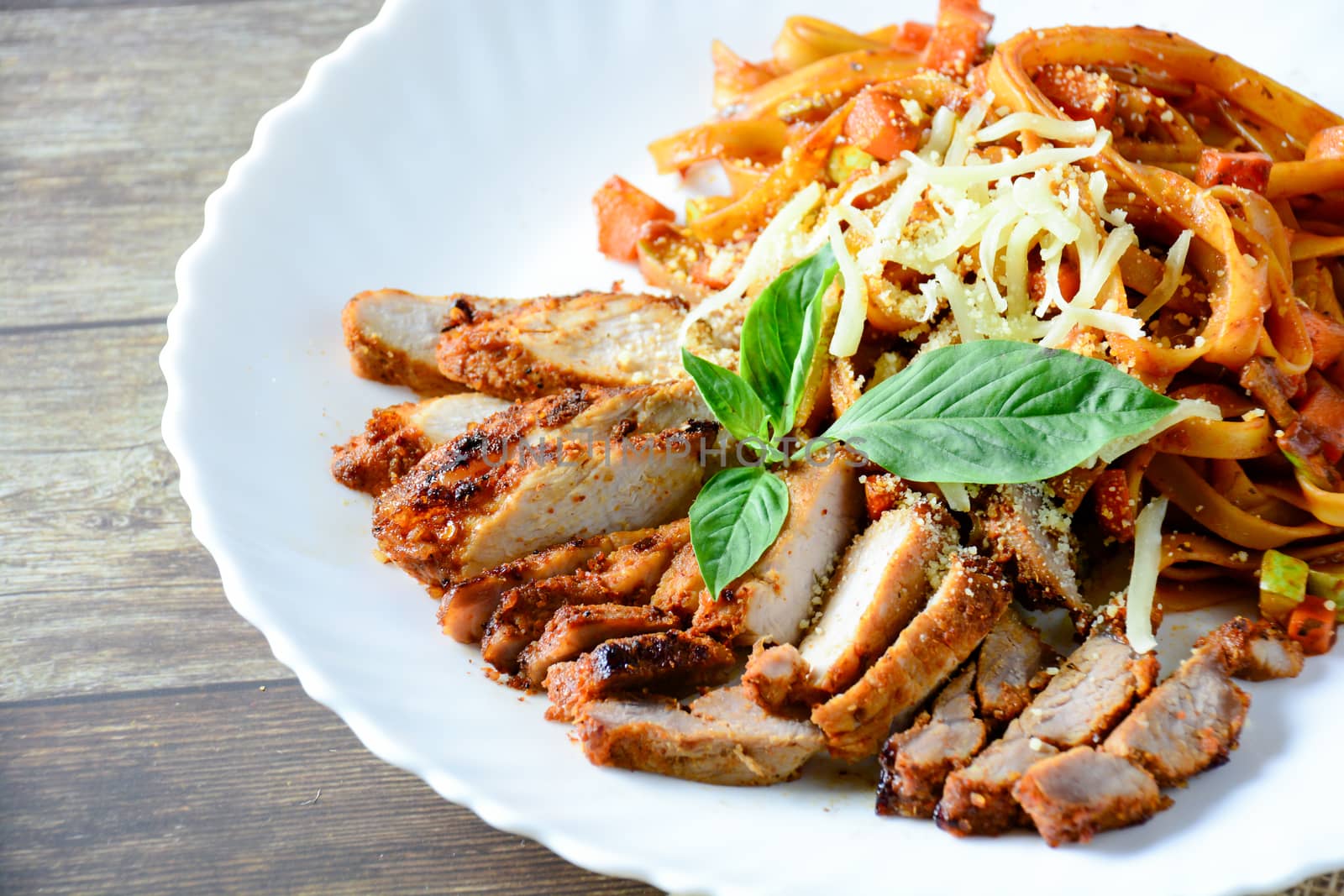 Steak meat with spaghetti and cheese on wood background. by yuiyuize