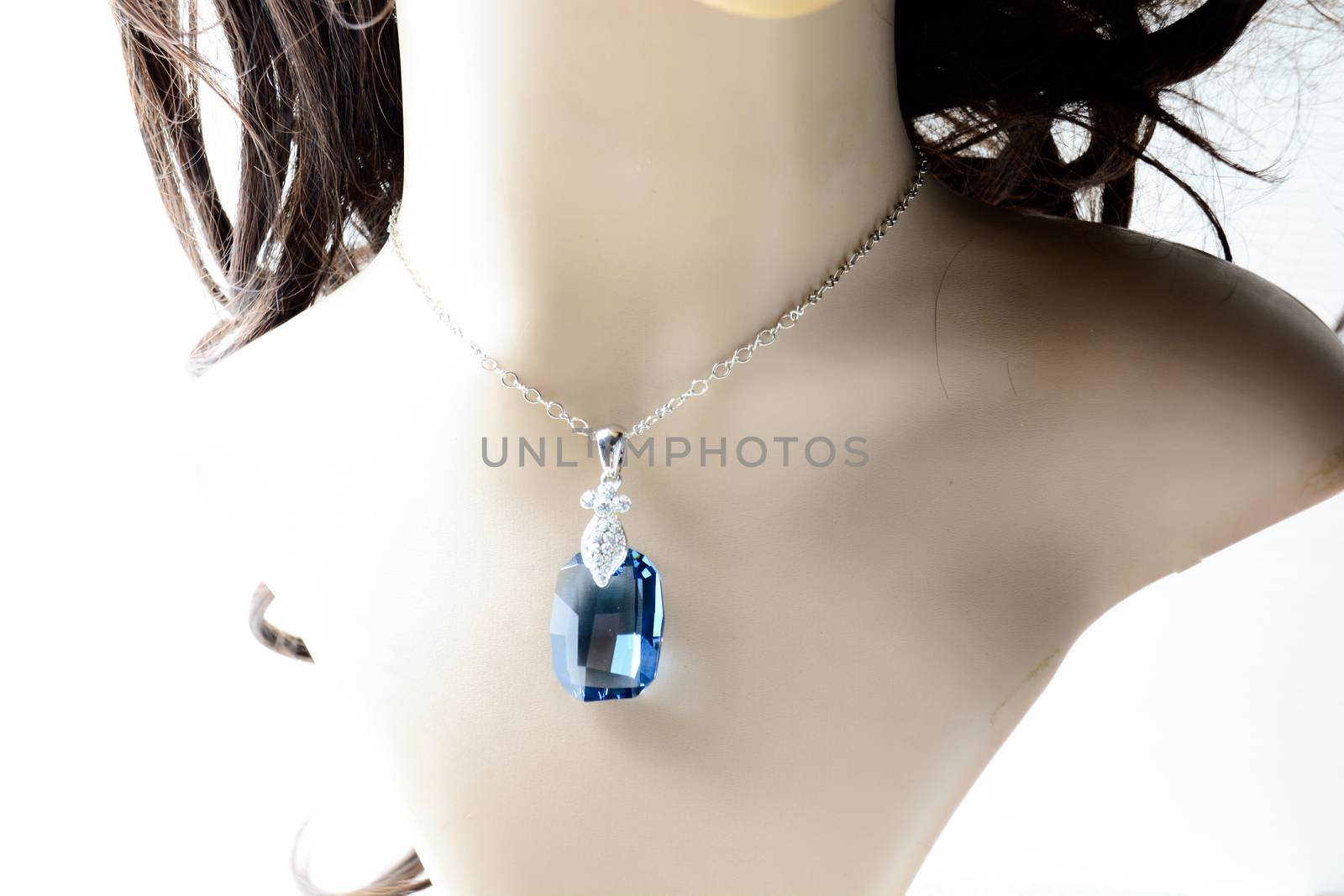 Crystal necklace on mannequin and on white background
