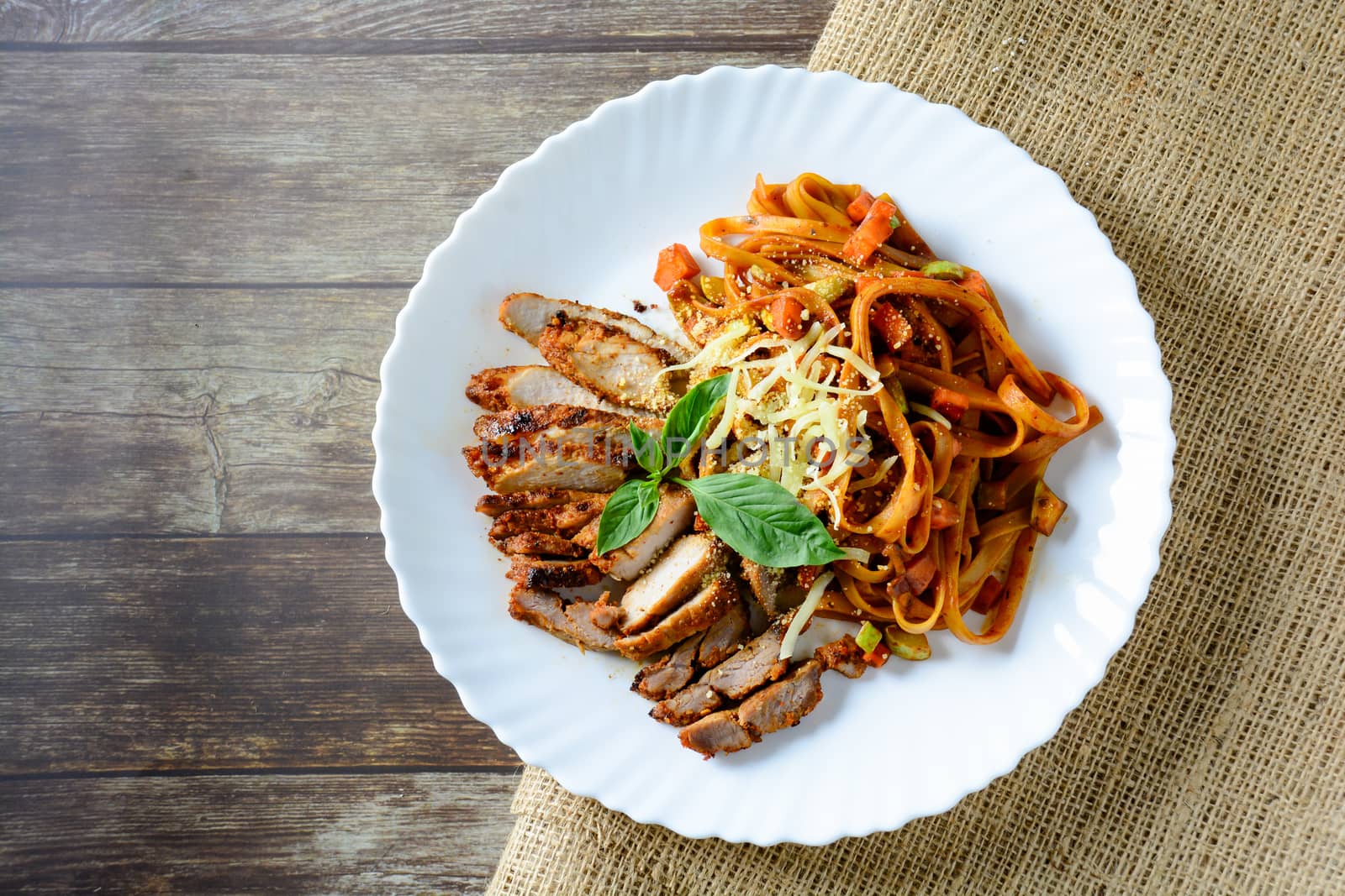 Steak meat with spaghetti and cheese on wood background. by yuiyuize