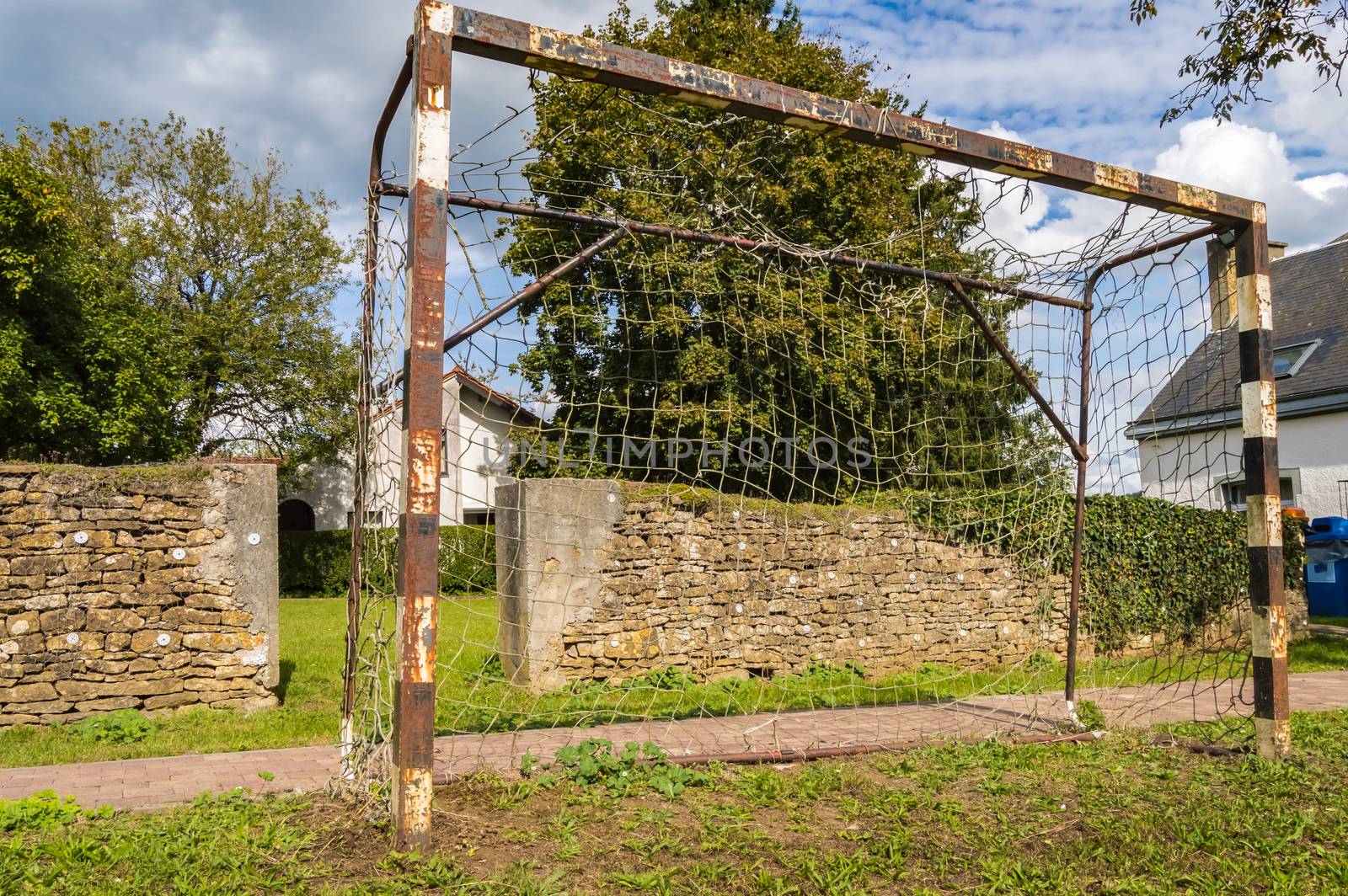 Rusty soccer goal a little rusty on a lawn by Philou1000