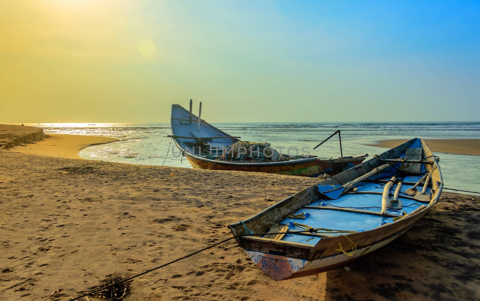 Traditional colorful fishing boat anchored at the confluence of Mahendra Tanaya river and Bay of Bengal, copy space