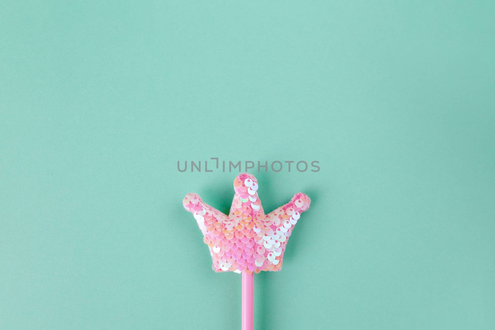 Party accessory, fairy wand. Pastel turquoise background, copy space. Holiday festive flat lay. Minimal style. Horizontal.