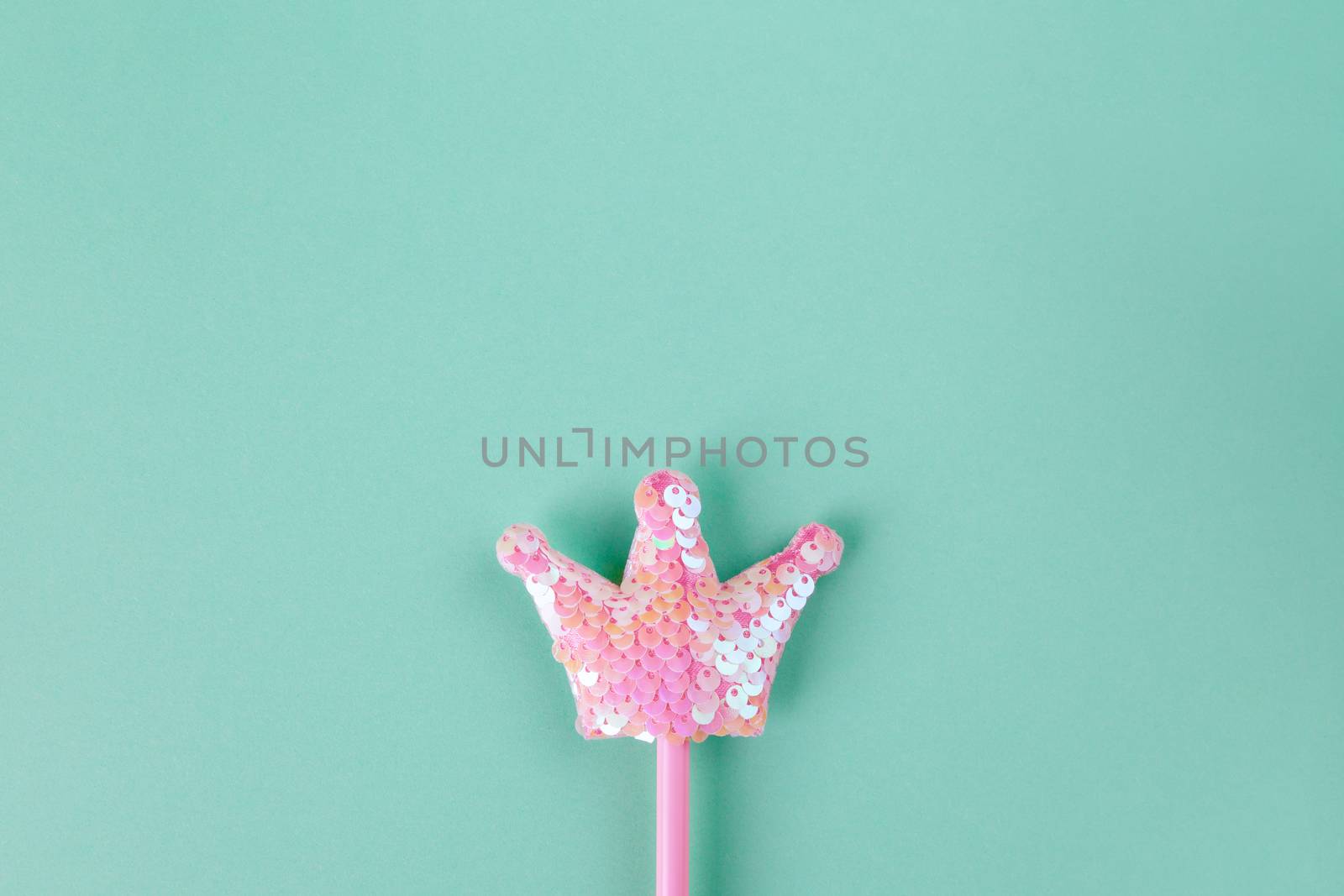 Party accessory, fairy wand. Pastel turquoise background, copy space. Holiday festive flat lay. Minimal style. Horizontal by ALLUNEED