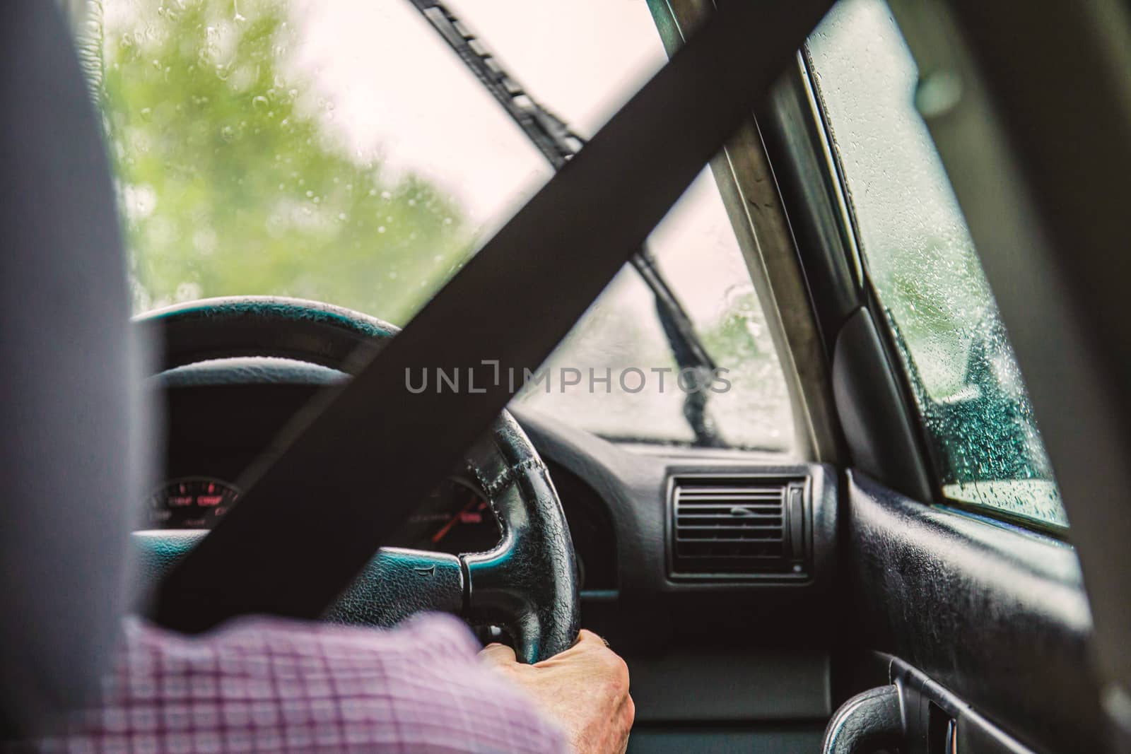 Man in righthand drive car wearing seatbelt