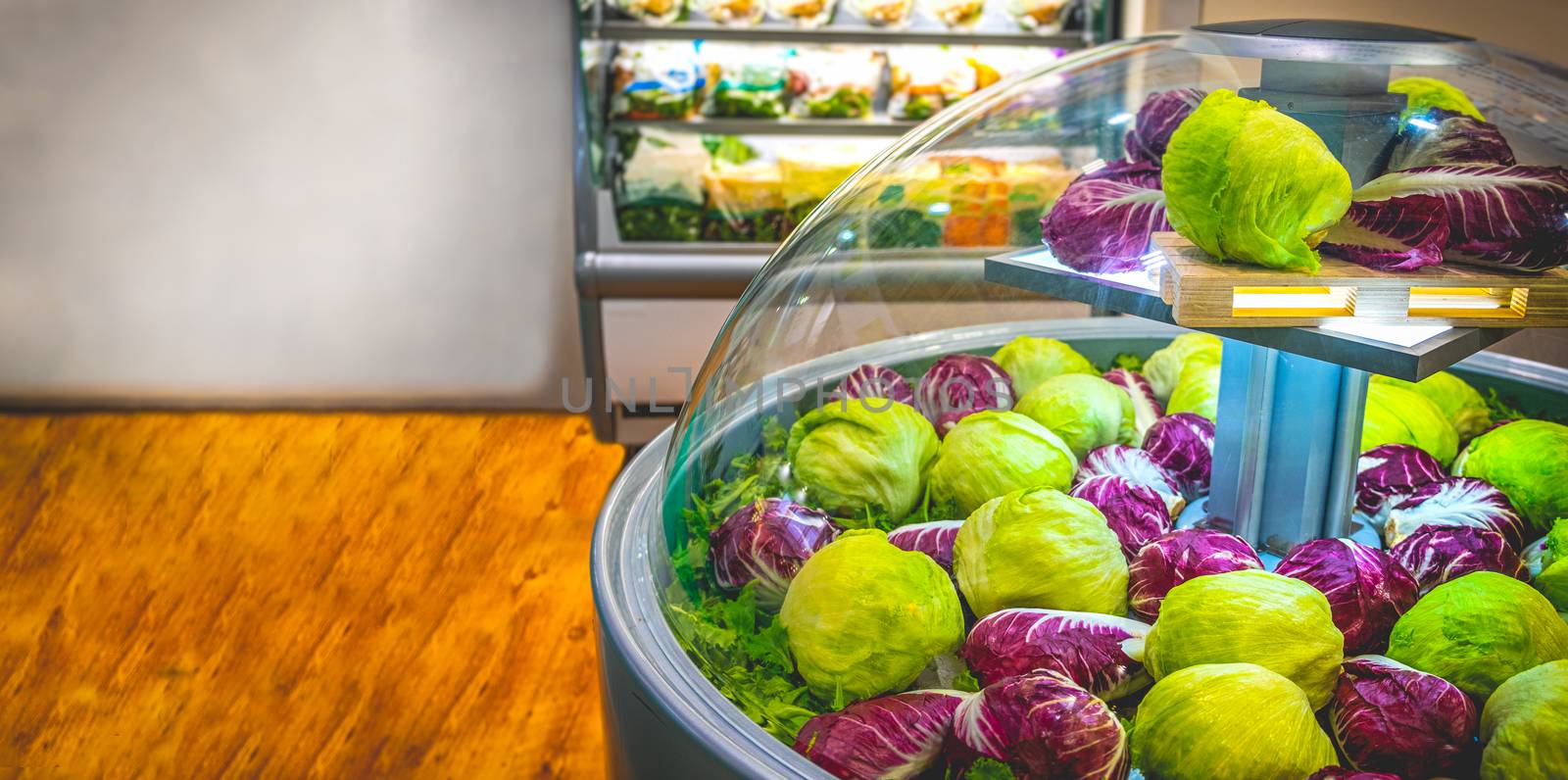 vegetable market refrigerator lettuce salad at supermarket horizontal background by LucaLorenzelli