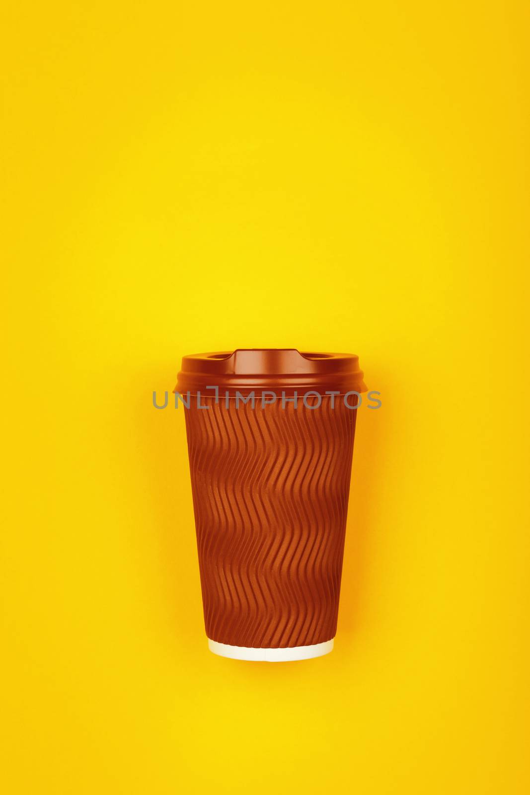 Brown paper coffee cup over yellow by BreakingTheWalls