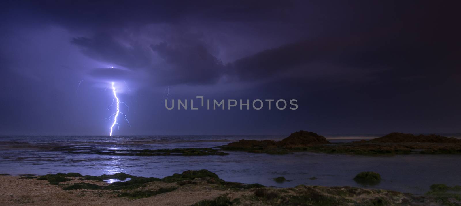 Thunderstorm on mediterranean sea beach by javax
