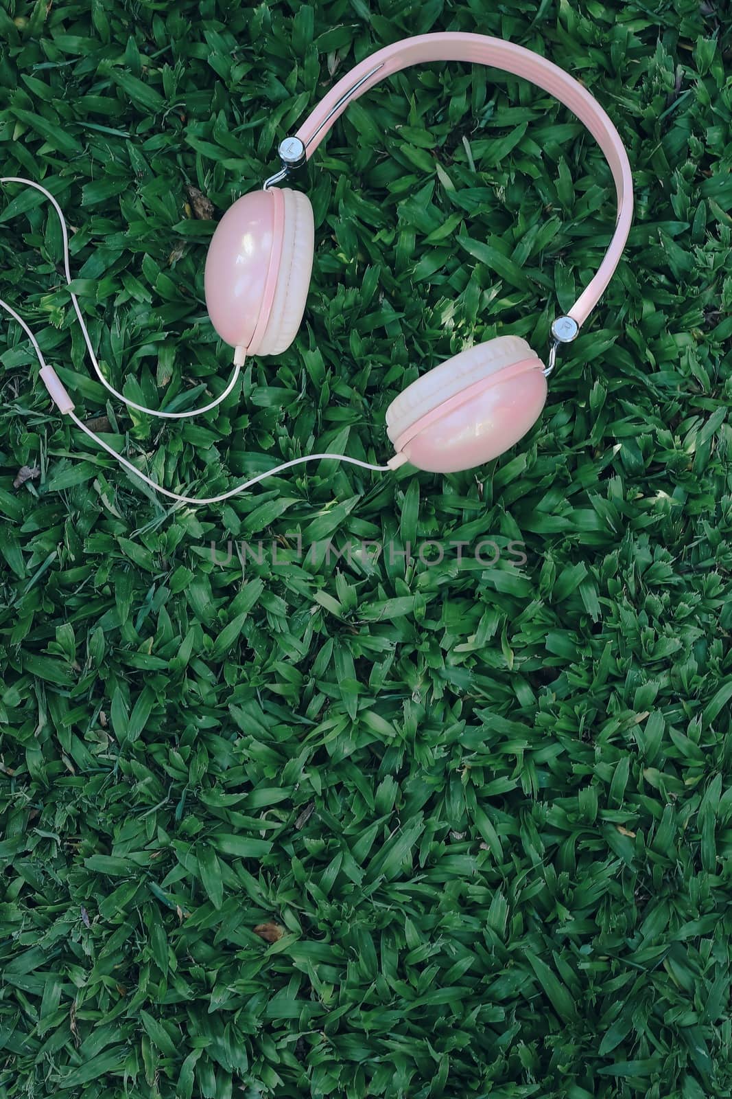 Music headphones on the green grass by aekgasit
