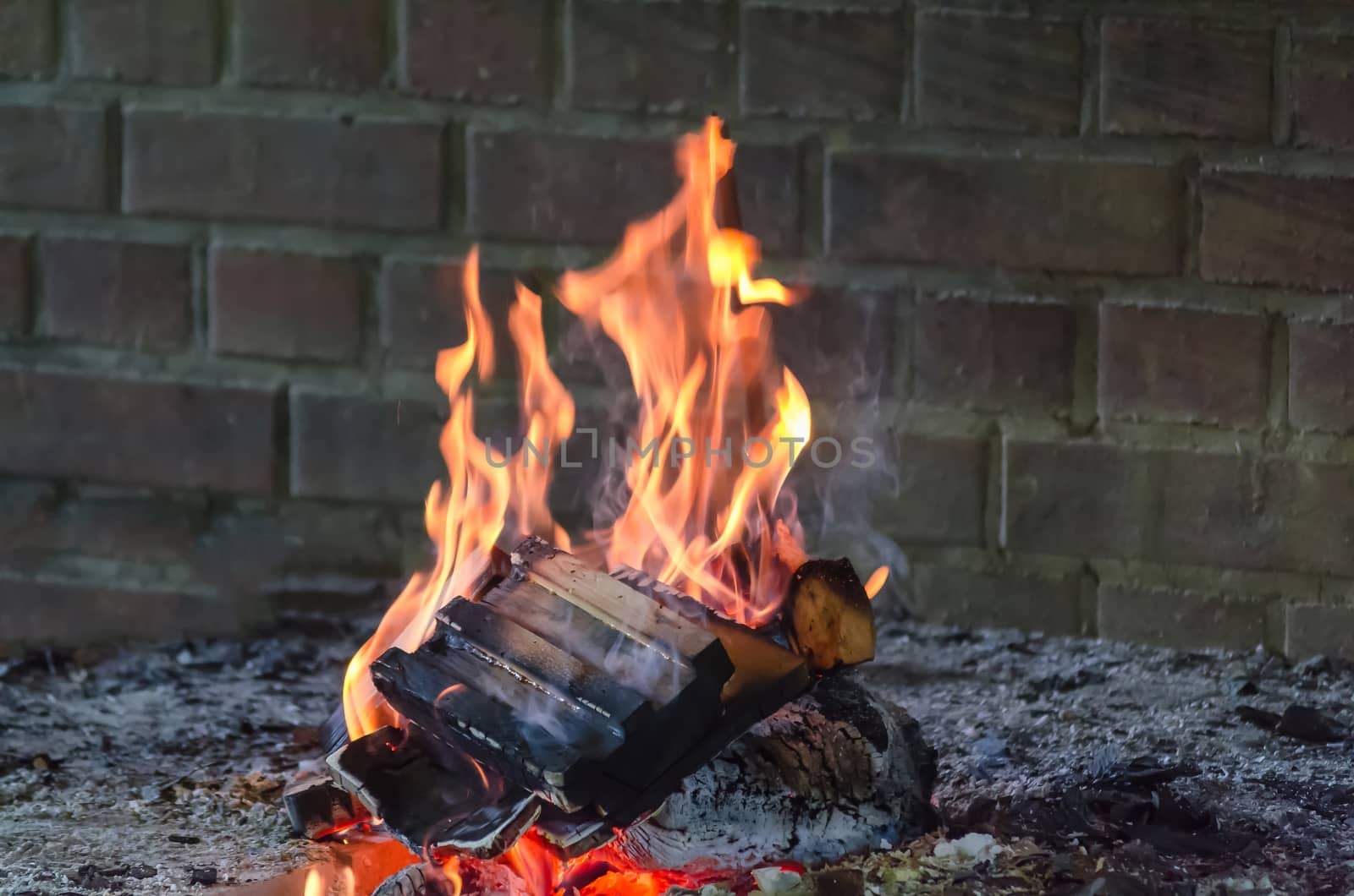 Glowing wooden log burning in the clear fire close up.        by JFsPic