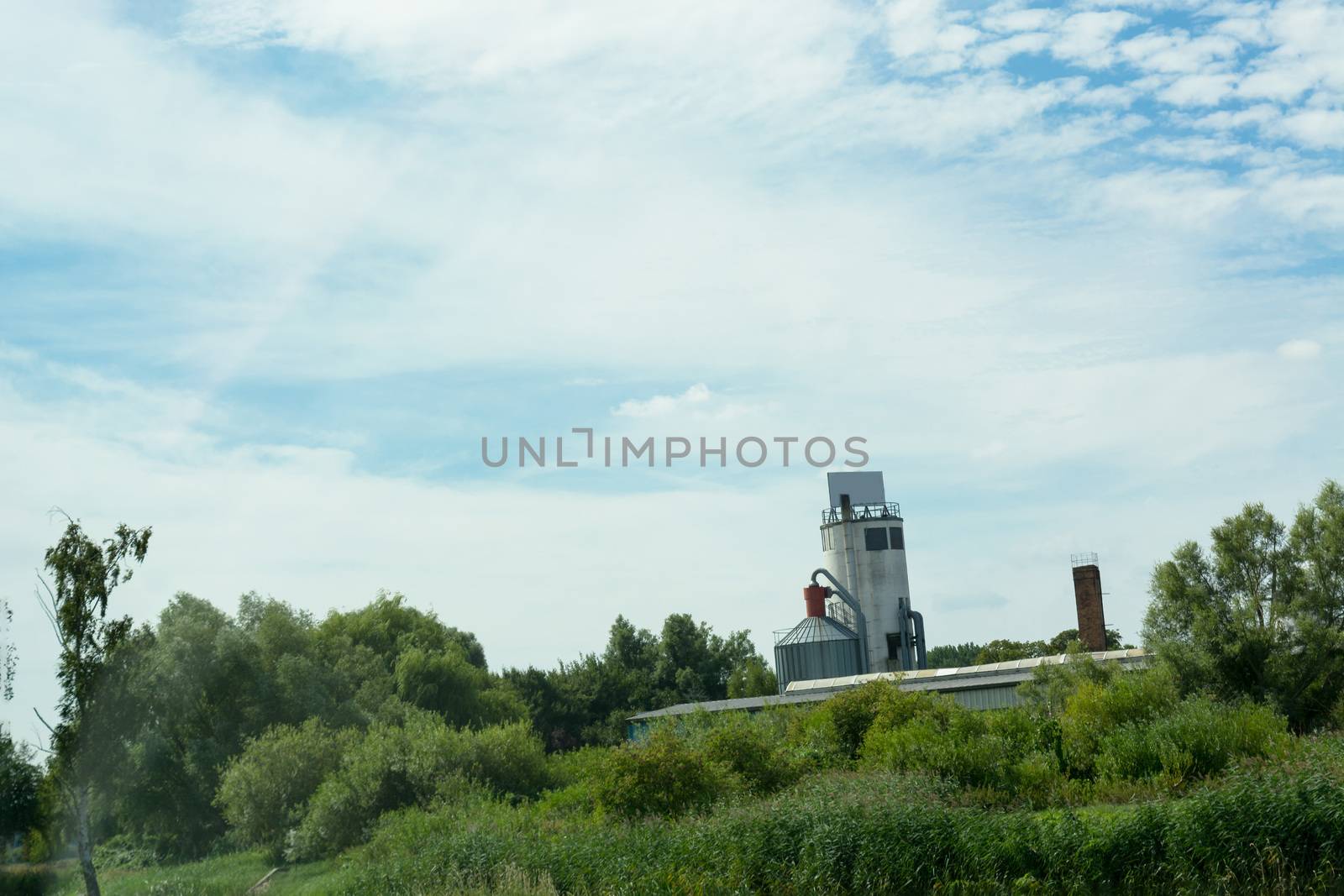 Countryside panorama blue sky with farm and silo plant in the background