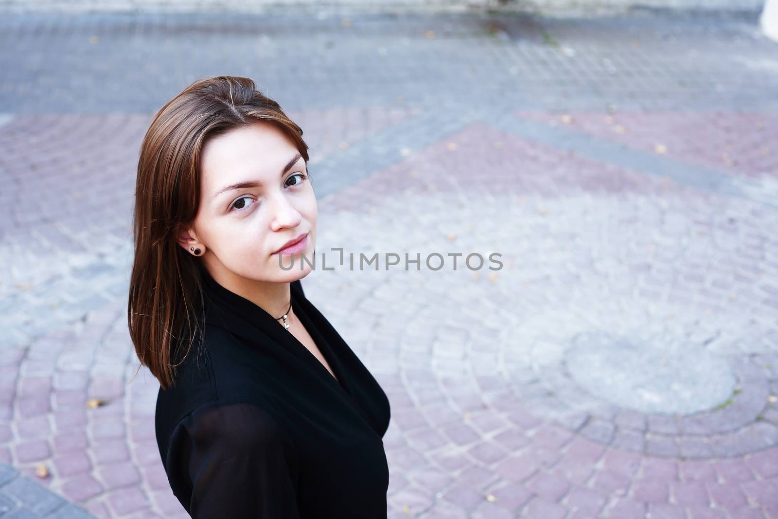 Beauty young woman against nice gray pavement background
