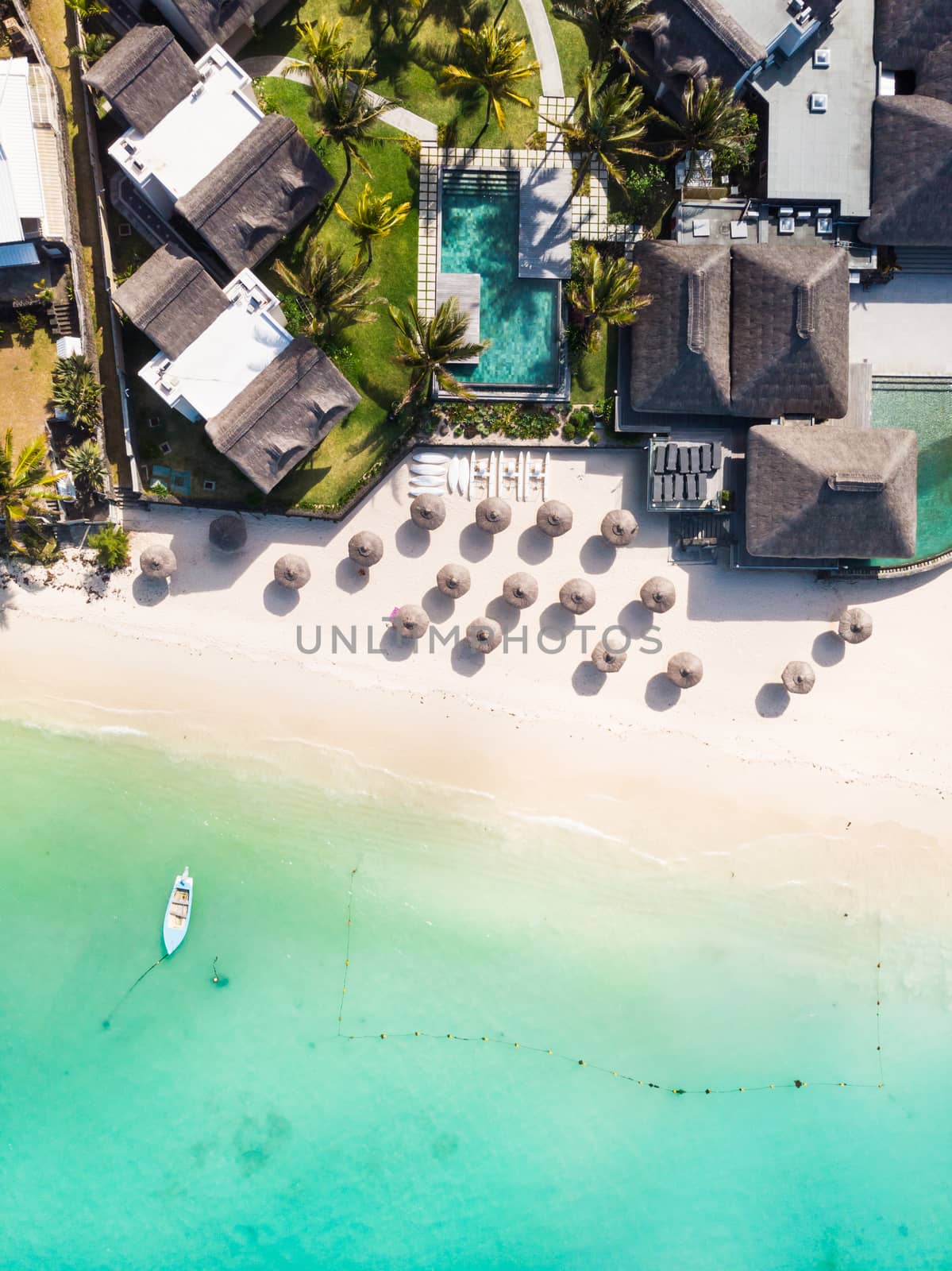 Aerial view of amazing tropical white sandy beach with palm leaves umbrellas and turquoise sea, Mauritius. by kasto