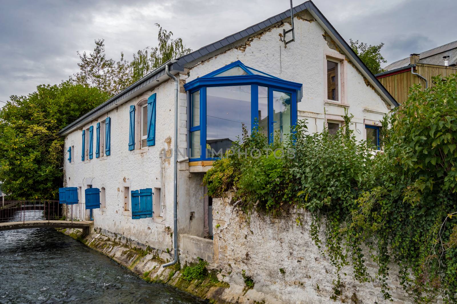 Old house along the river of tone with blue shutters  by Philou1000