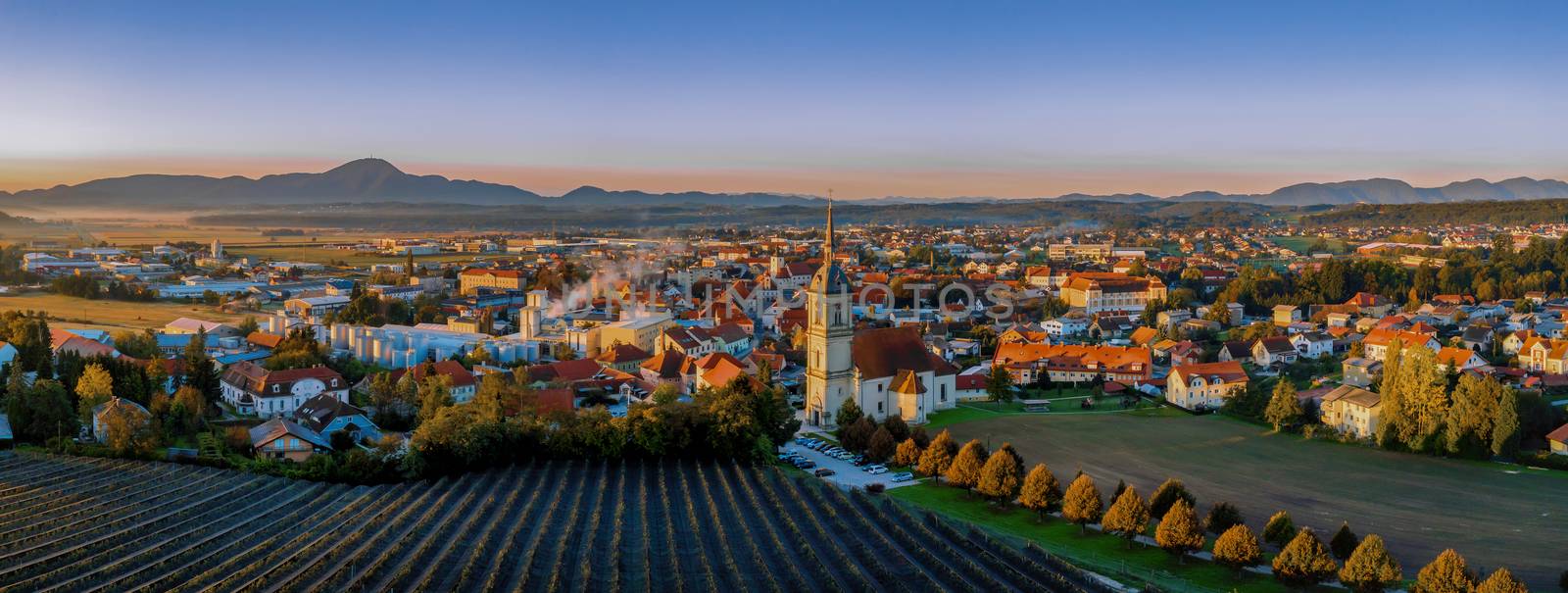 Aerial Panorama view of small medieval european town Slovenska Bistrica, Slovenia with church and castle in sunrise