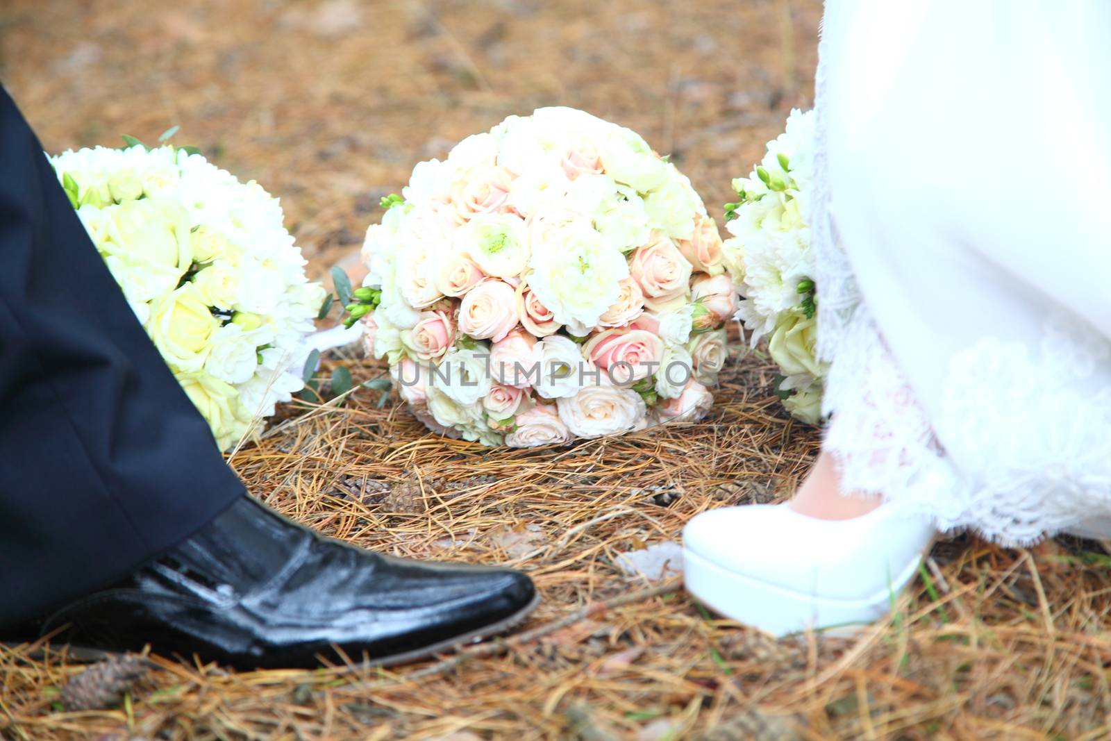 bride and groom's shoes on the background of a wedding bouquet