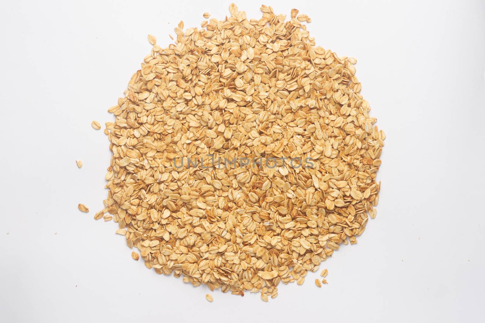 Cereal flakes for granola closeup. Flakes isolated on white background. Nutrition concept. Cereal flakes stock photo.