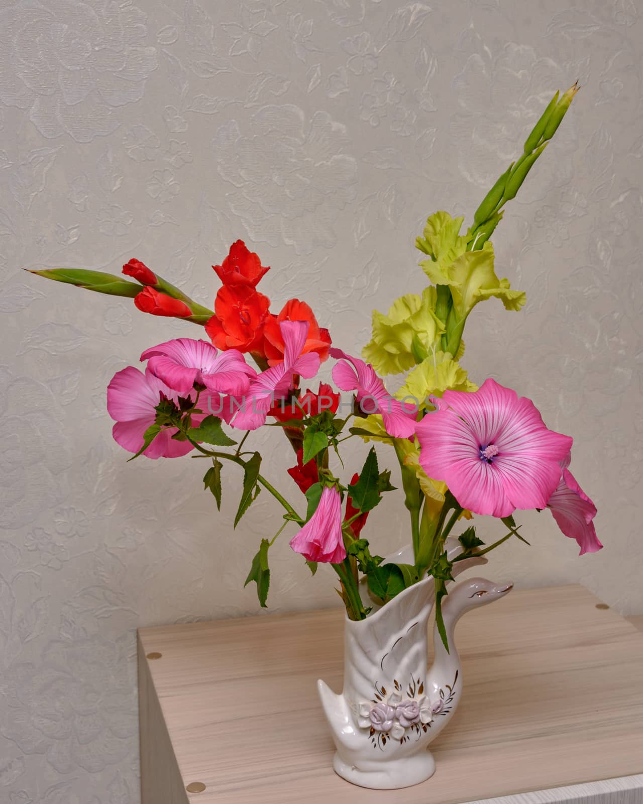 Bouquet of pink flowers in vase isolated on white background
