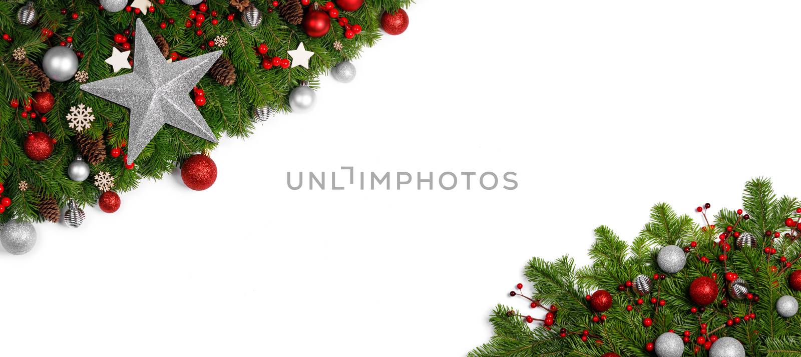 Christmas Border frame of tree branches on white background with copy space isolated, red and silver decor, berries, stars, cones