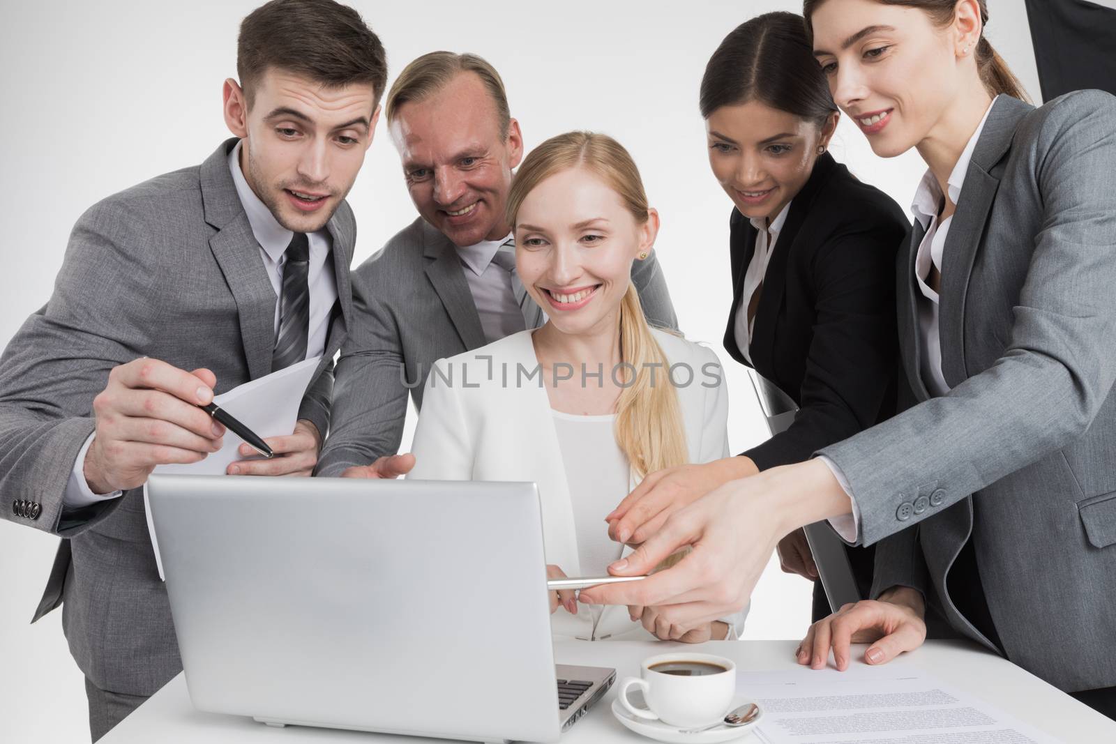 Business people looking at laptop screen working together, they rejoice