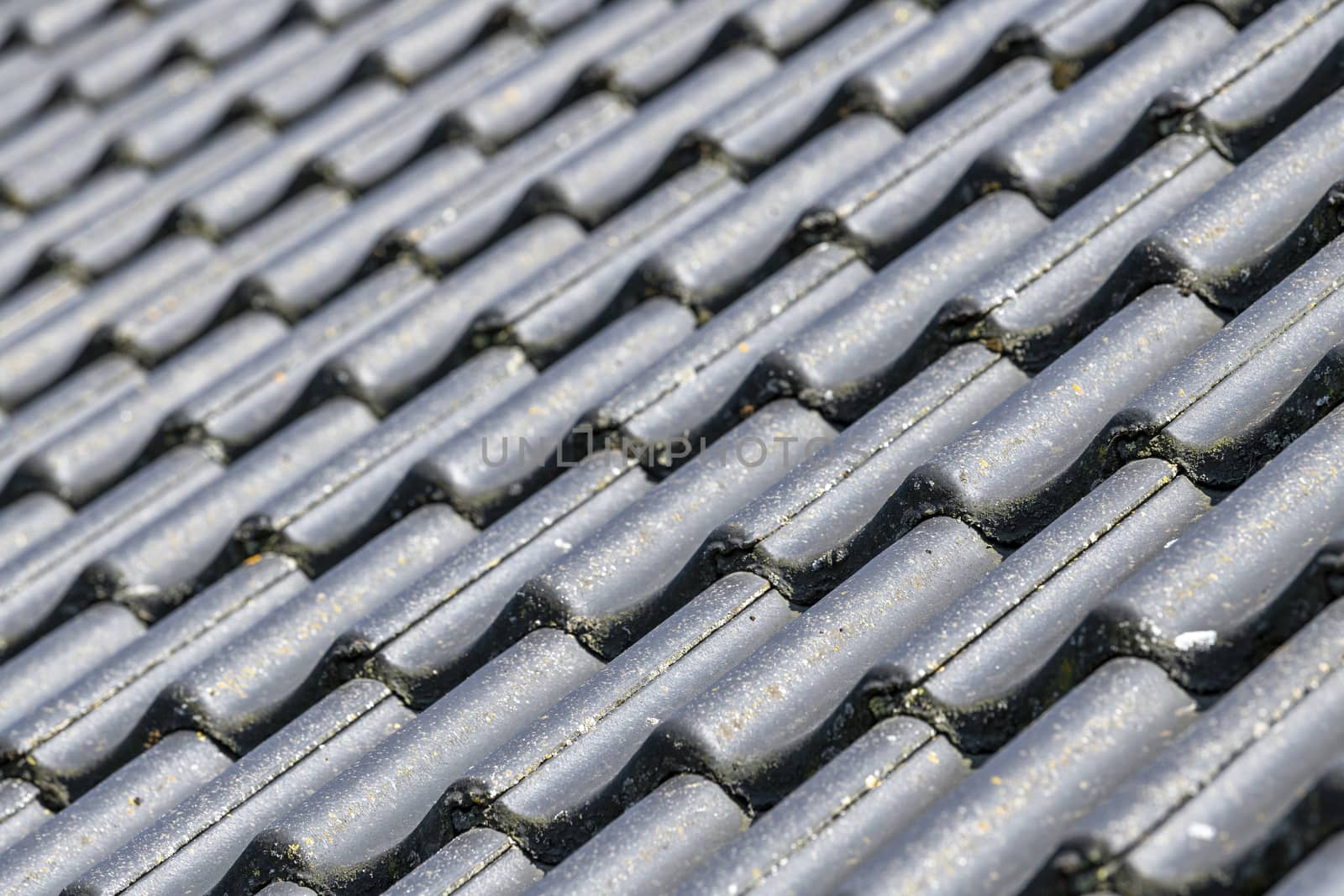 Pitched roof with black concrete tiles displayed full screen background picture
