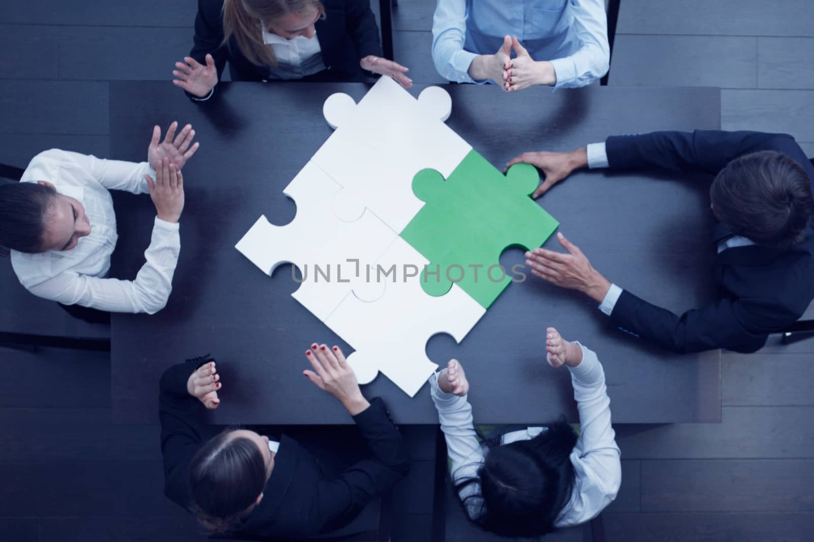 Group of business people assembling jigsaw puzzle, team support problem solution and help concept