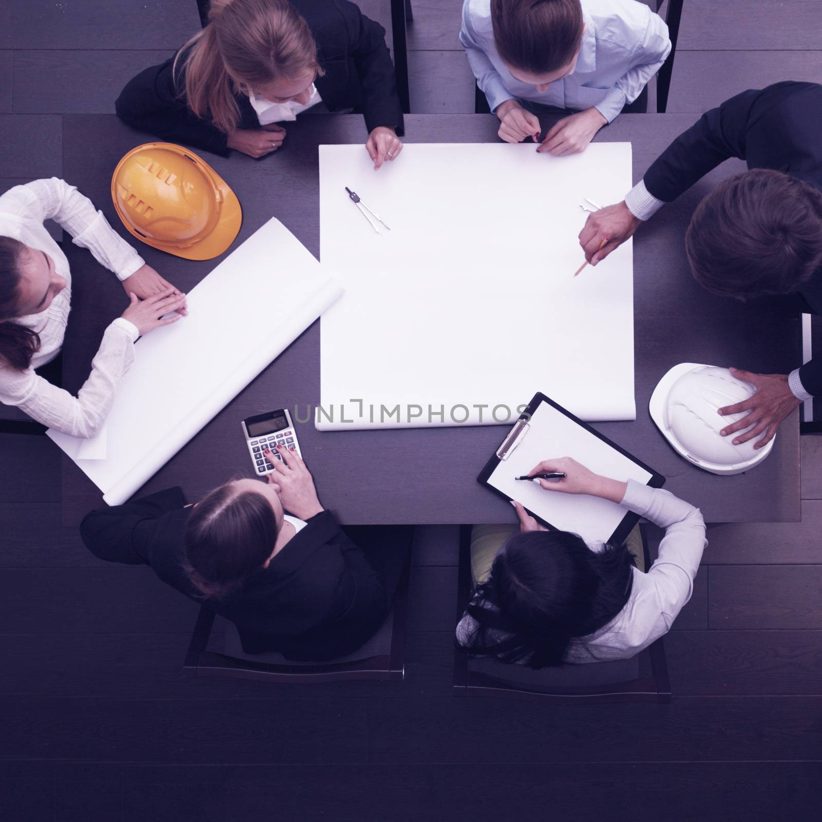 Top view of people around table in construction business meeting, blank paper with copy space