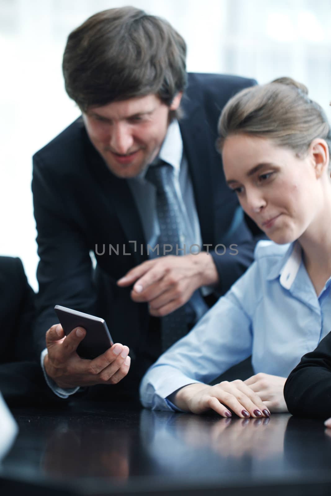 Group of business people working at office and using smartphone