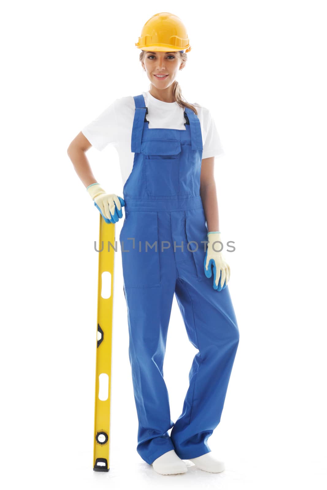 Young beautiful handywoman with building level isolated on white background
