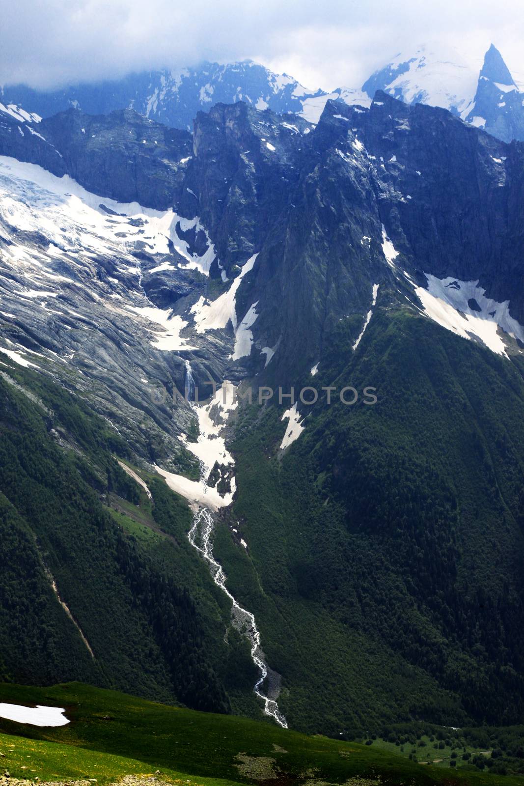 Panorama of mountains scene with dramatic blue sky in national park of Dombay